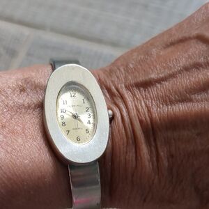 Brian Stu women's silver-tone cuff Oval watch. 